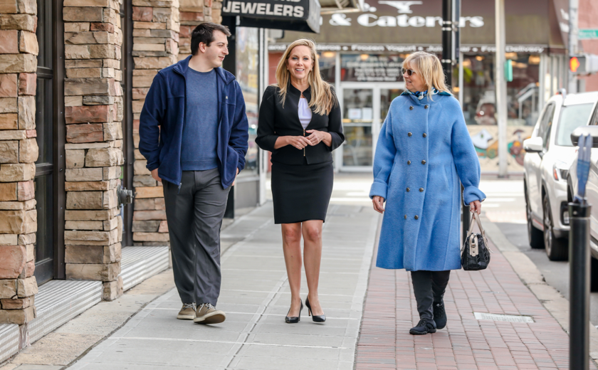 Laura walking down the street with two people